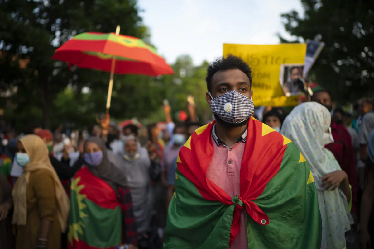 Protesters outraged by the killing of popular Ethiopian singer Hachalu Hundessa walk along Lexington Avenue after exiting off westbound Interstate 94, in St. Paul, Minn., on July 1, 2020. (Jeff Wheeler/Star Tribune via AP/File)