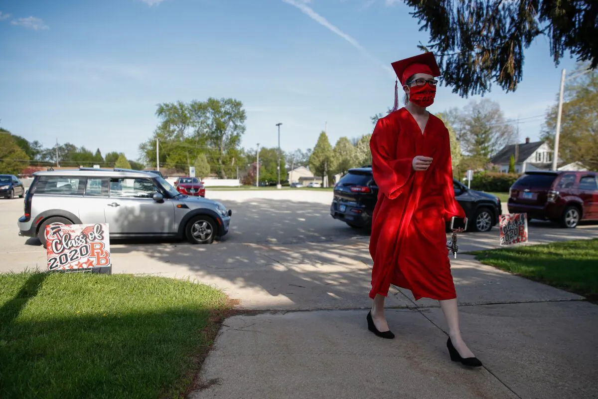 A graduate student arrives to pick up her diploma at Bradley-Bourbonnais Community High School on May 6, 2020 in Bradley, Ill. (Kamil Krzaczynski/AFP via Getty Images)