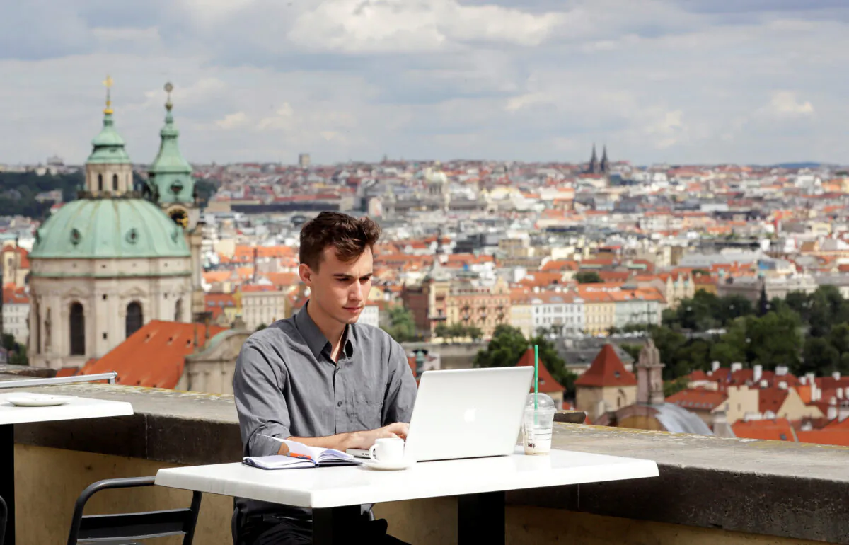 Joseph Petrila, a 23 years old job seeker, uses a laptop in a cafe near the Prague Castle following the coronavirus disease (COVID-19) outbreak, in Prague, Czech Republic, on July 8, 2020. (David W Cerny/Reuters)