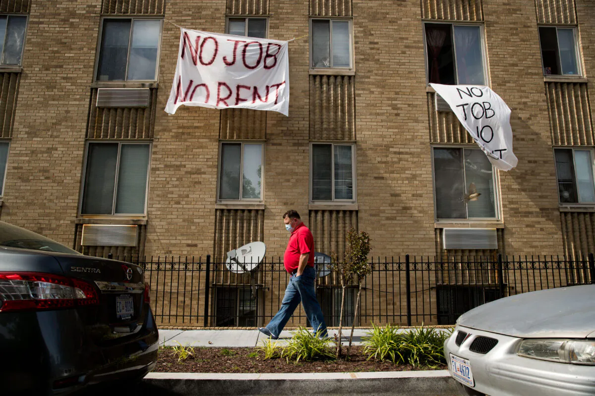 Signs that read "No Job No Rent" hang from the windows of an apartment building in Washington on May 20, 2020. (Andrew Harnik/AP Photo)