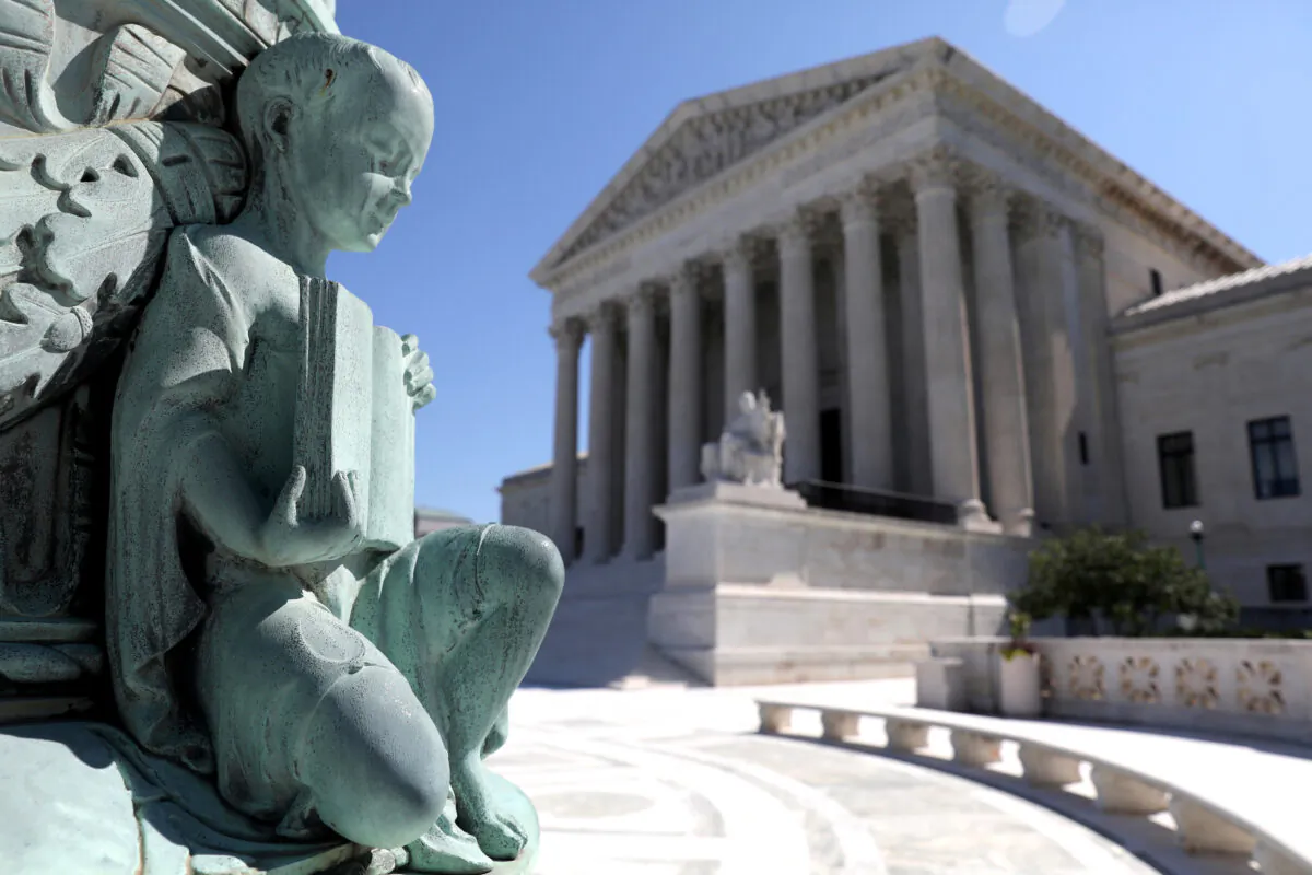 A cherub figure with a book, symbolizing learning, is seen in a general view of the U.S. Supreme Court building in Washington, on July 2, 2020. (Jonathan Ernst/Reuters)