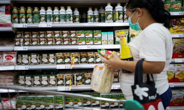 A woman shops coconut products at a supermarket in Bangkok, Thailand, on July 6, 2020. (Athit Perawongmetha/Reuters)