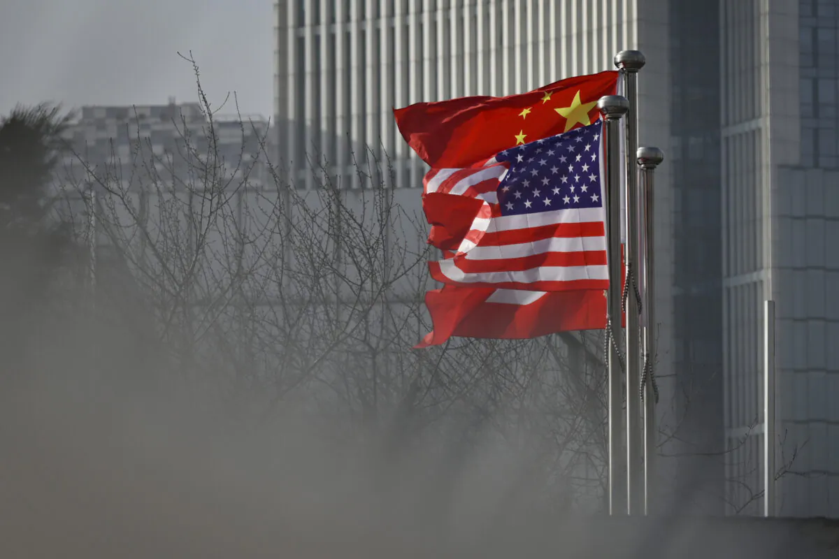 Chinese and U.S. national flags flutter at the entrance of a company office building in Beijing on Jan. 19, 2020. (Wang Zhao/AFP via Getty Images)