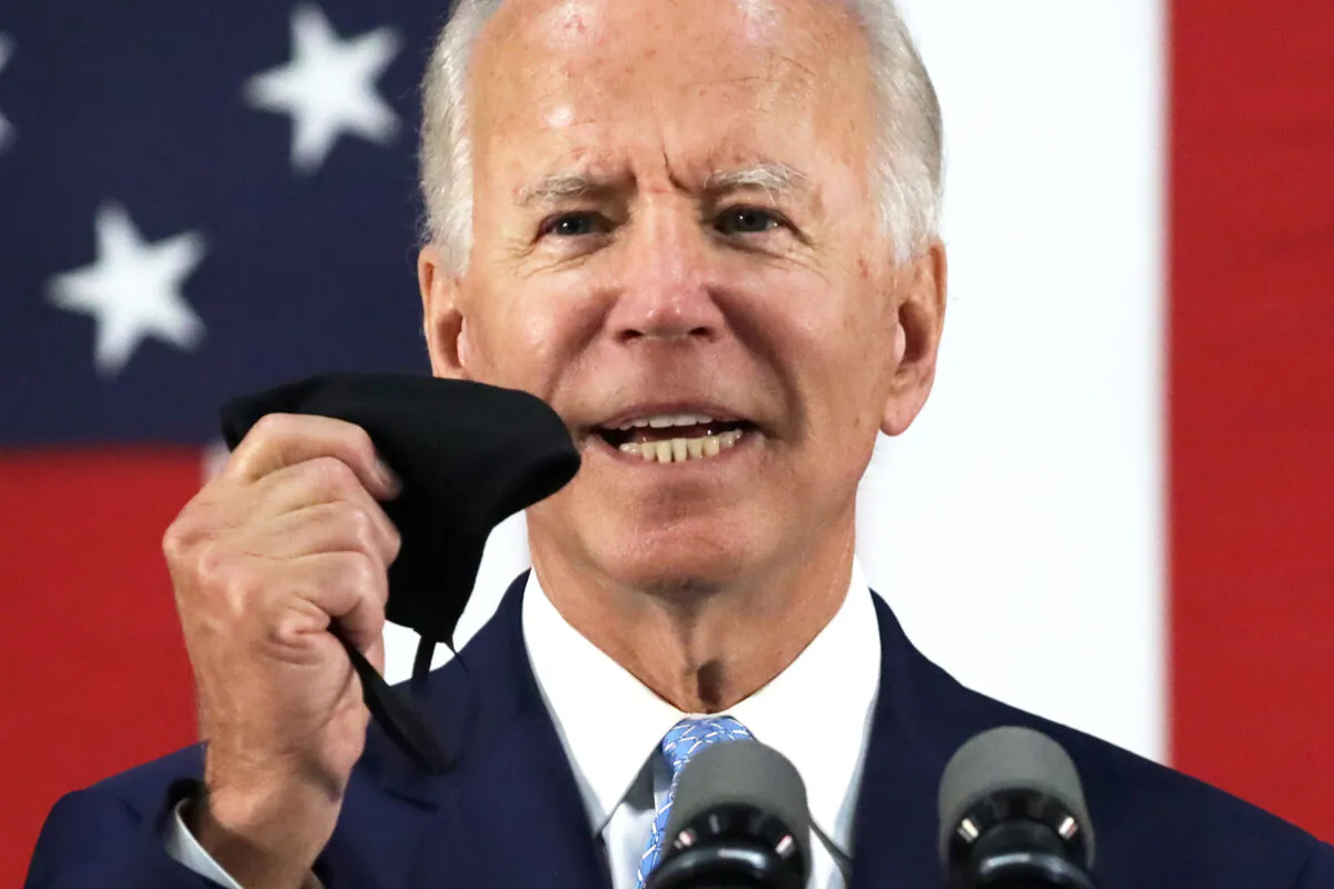 Democratic presidential candidate and former Vice President Joe Biden holds up a mask as he speaks during a campaign event in Wilmington, Del., on June 30, 2020. (Alex Wong/Getty Images)