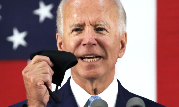 Democratic presidential candidate and former Vice President Joe Biden holds up a mask as he speaks during a campaign event in Wilmington, Del., on June 30, 2020. (Alex Wong/Getty Images)