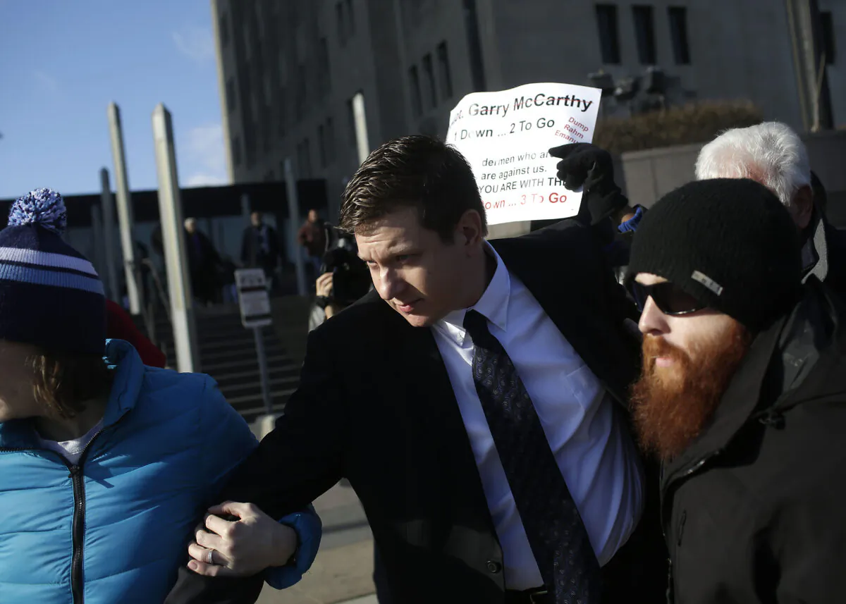 Former Chicago police officer Jason Van Dyke, center, who was charged with murder in the shooting of Laquan McDonald, leaves the Cook County Criminal Court after his status hearing in Chicago on Dec. 18, 2015. Van Dyke was convicted of murder and sentenced to 81 months in prison. (Joshua Lott/Getty Images)