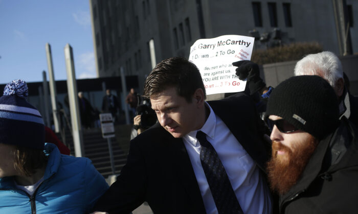 Former Chicago police officer Jason Van Dyke, center, who was charged with murder in the shooting of Laquan McDonald, leaves the Cook County Criminal Court after his status hearing in Chicago on Dec. 18, 2015. Van Dyke was convicted of murder and sentenced to 81 months in prison. (Joshua Lott/Getty Images)