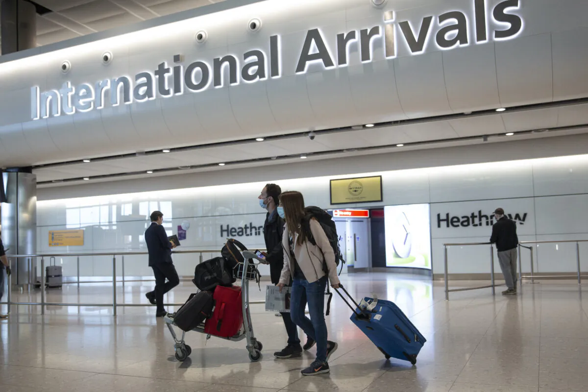 Passengers walk in London's Heathrow Airport, on July 8, 2020. (Matt Dunham/AP Photo)