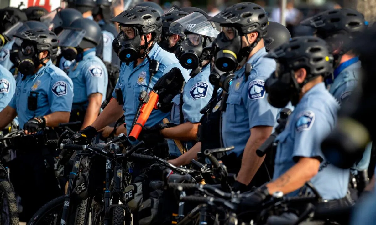 In this May 27, 2020, file photo, police gather en masse as protests continue at the Minneapolis 3rd Police Precinct in Minneapolis. (Carlos Gonzalez/Star Tribune/AP) 