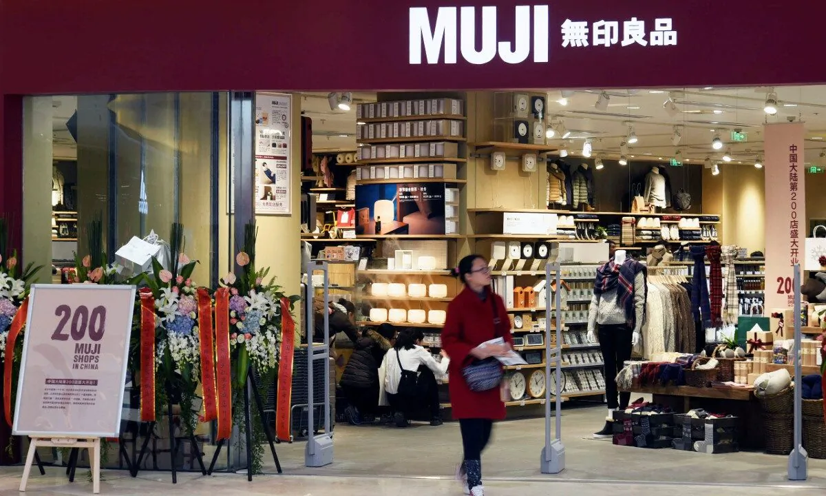 A woman walks outside a newly opened Muji store at a shopping mall in Hangzhou, Zhejiang province, China, December 12, 2016. (Stringer/Reuters)