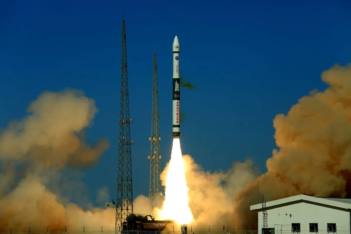 A Kuaizhou-1A carrier rocket with a Chinese character slogan that reads "Heroic Wuhan, Great China" lifts off from the Jiuquan Satellite Launch Centre in China's northwest Gansu province carrying two communications satellites on May 12, 2020. (STR/AFP via Getty Images)