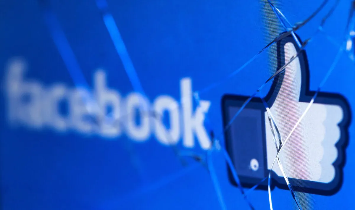 The logo of the social network Facebook on a broken screen of a mobile phone on May 16, 2018. (Joel Saget/AFP via Getty Images)