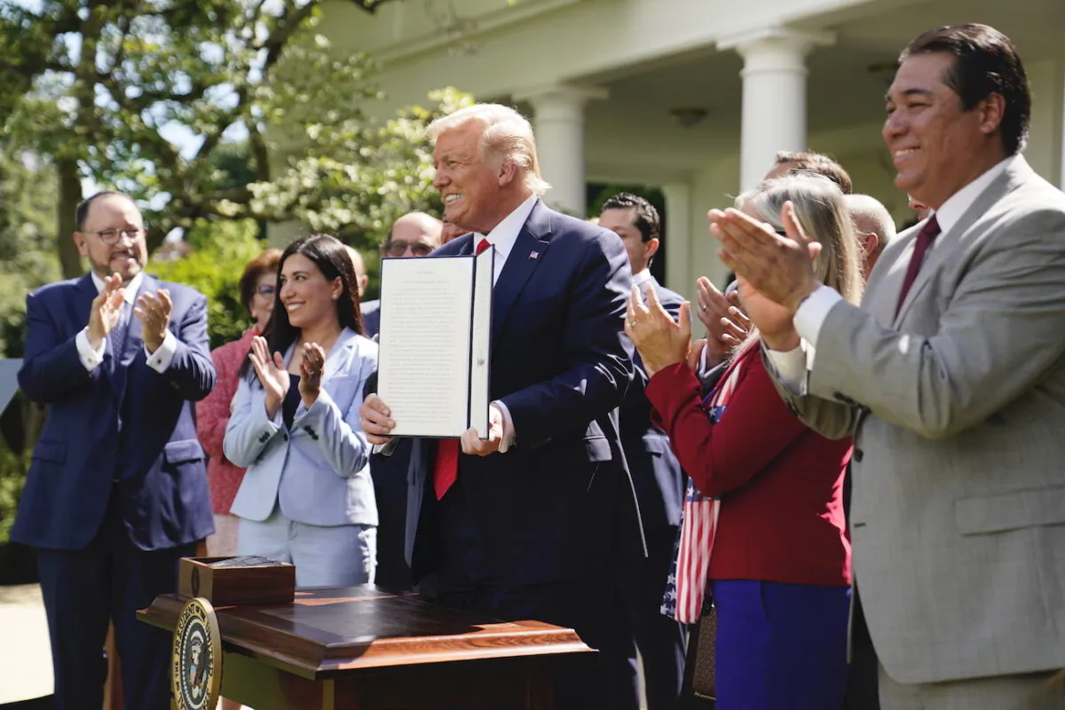 President Donald Trump holds an executive order on the "White House Hispanic Prosperity Initiative," after signing it in the Rose Garden of the White House, in Washington, on July 9, 2020. (Evan Vucci/AP Photo)