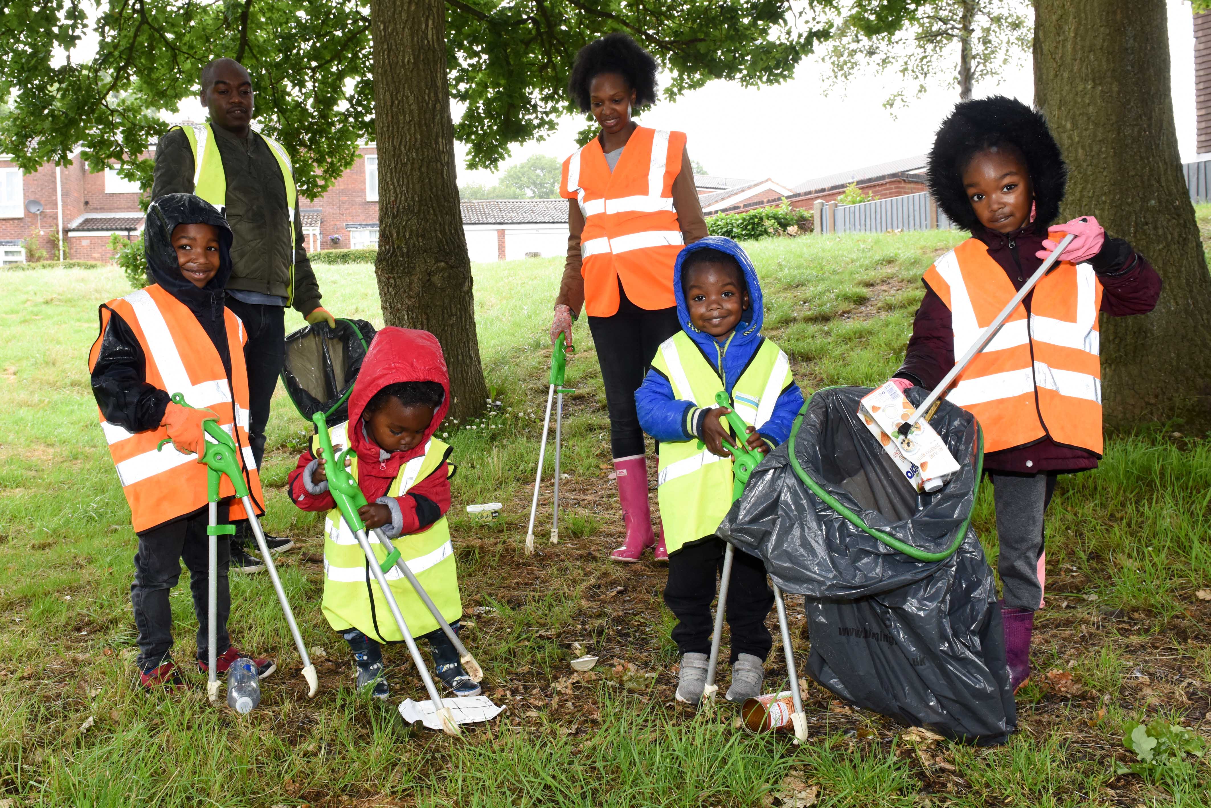 Kids Picking Up Trash In Classroom