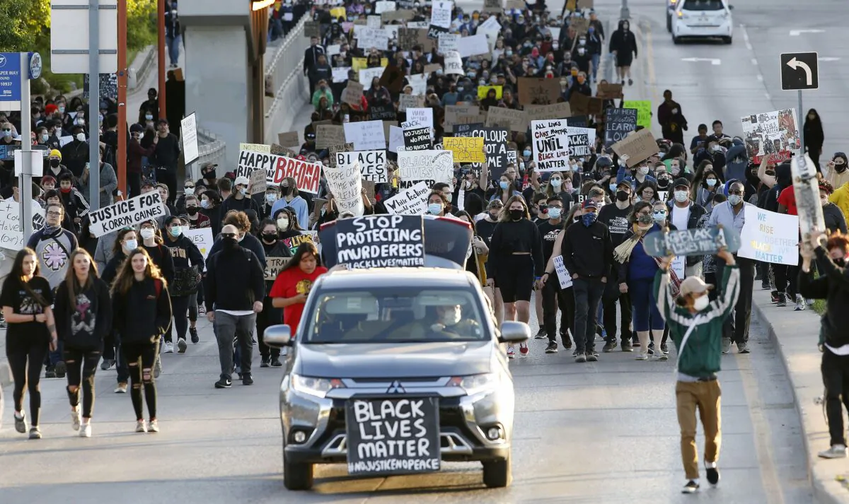 People march at a Black Lives Matter rally in Winnipeg on June 5, 2020, in solidarity with the George Floyd protests across the United States. (The Canadian Press/John Woods)
