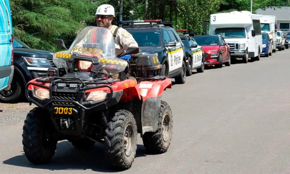 A police officer drives his quad on a street, on July 10, 2020 in Saint-Apollinaire, Que. (Jacques Boissinot/The Canadian Press) 
