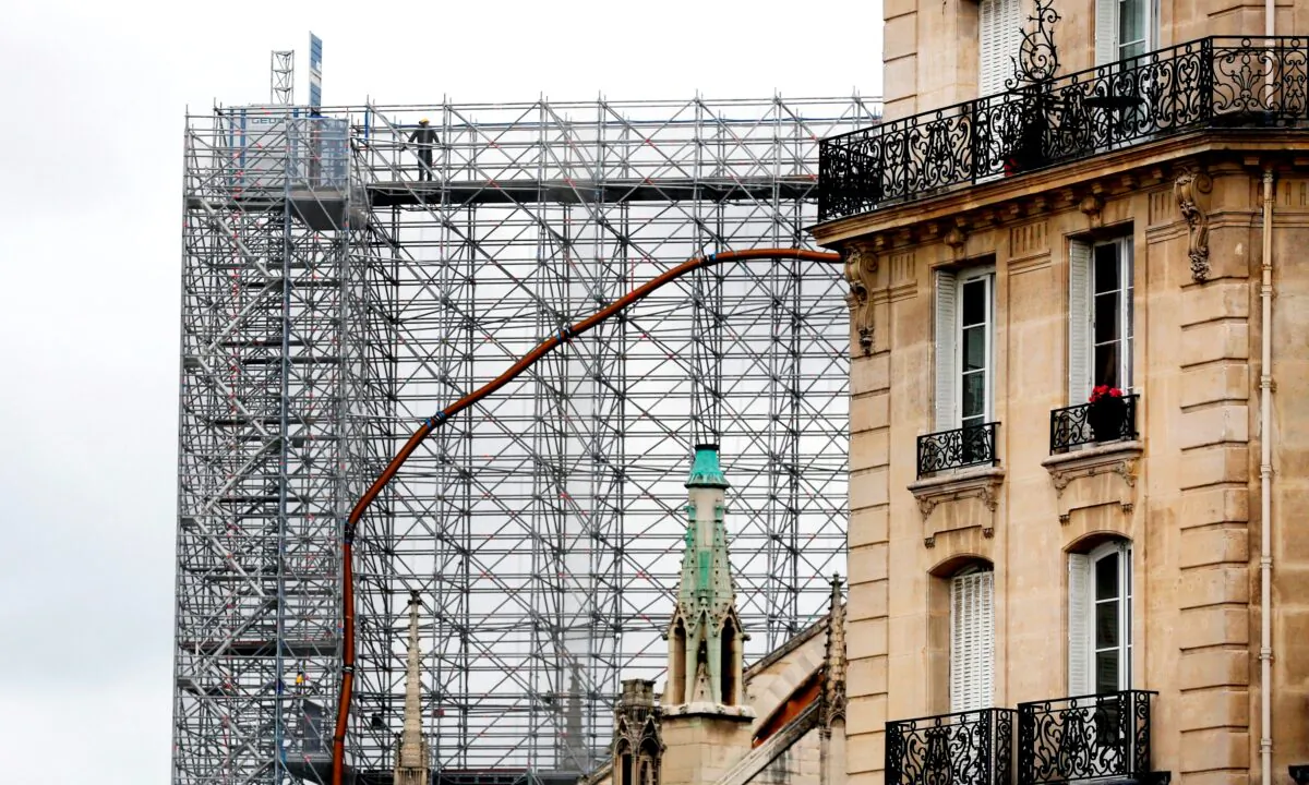 A worker stands on a scaffolding at Notre Dame cathedral, in Paris, France, on July 10, 2020. (Thibault Camus/AP Photo)