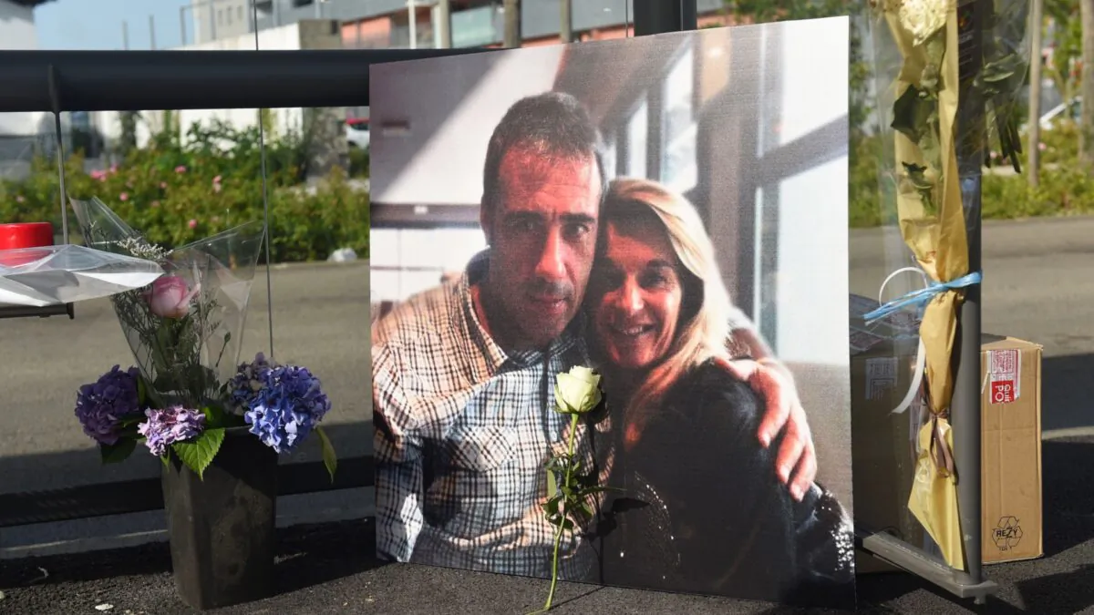 A picture of Veronique Monguillot and Philippe Monguillot, a bus driver declared brain dead after being attacked for refusing to let aboard a group of people who were not wearing face masks, is displayed during a white march in Bayonne, southwestern France, on July 8, 2020. (Iroz Gaizka/AFP via Getty Images)