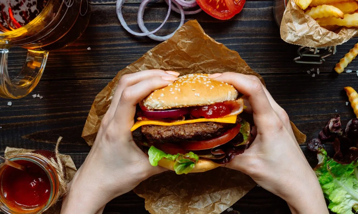 Don’t let go. While a pristine burger is a thing of beauty and balance, once the first bite is taken, it wants to explode. (Fedorovacz/Shutterstock)