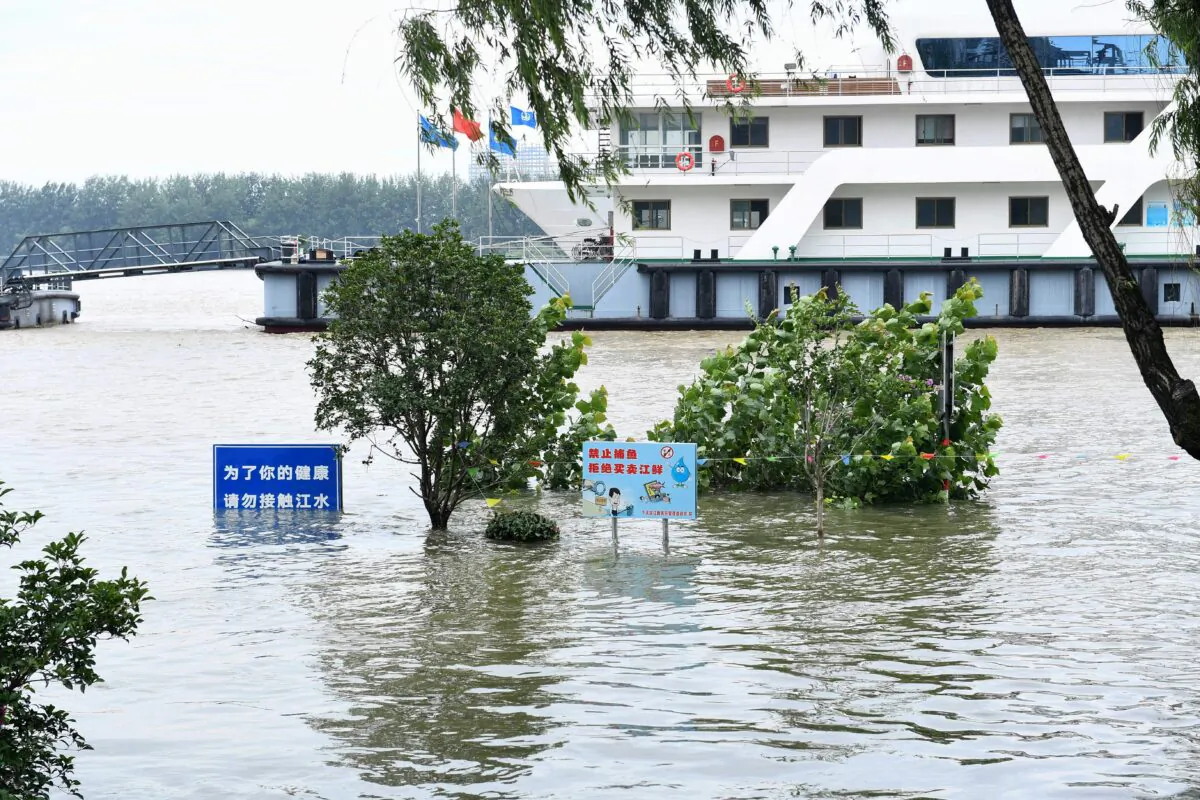 Signs are seen submerged in floodwaters on the bank of the Yangtze River in Nanjing, China on July 12, 2020. (STR/AFP via Getty Images)
