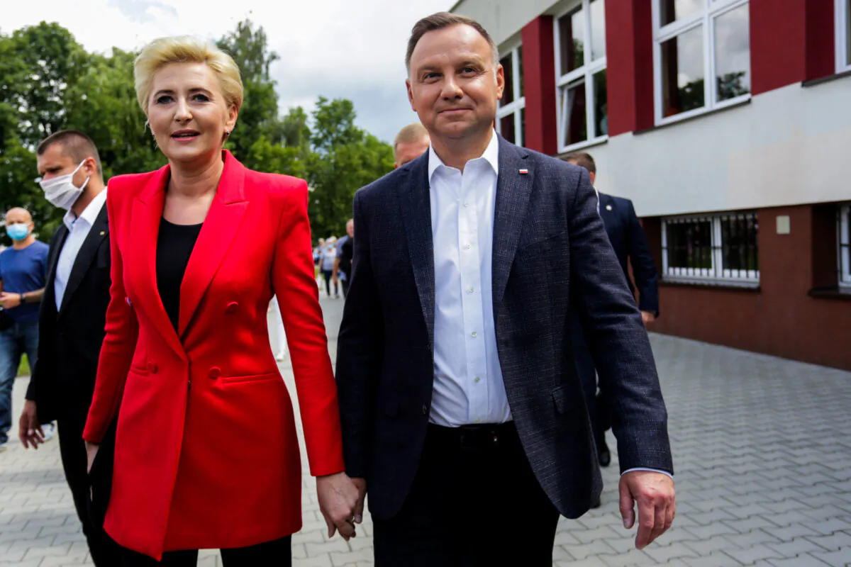 Polish President and presidential candidate Andrzej Duda and his wife Agata Kornhauser-Duda visit a polling station during the second round of a presidential election in Krakow, Poland, on July 12, 2020. (Adrianna Bochenek/Agencja Gazeta via Reuters)