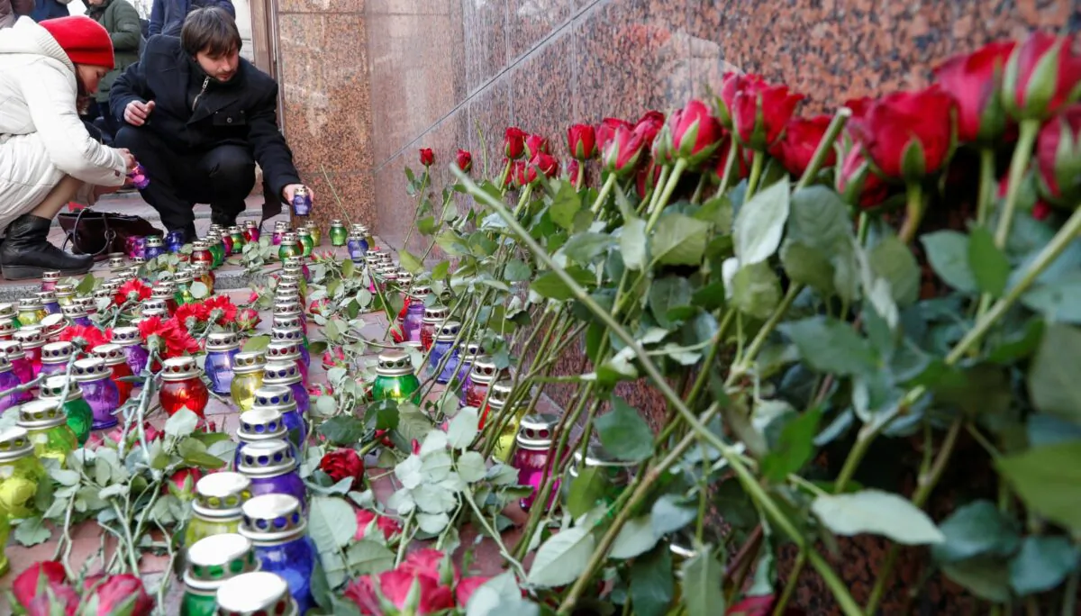 People place candles as they commemorate victims of the Ukraine International Airlines flight 752 plane disaster, in front of the Iranian embassy in Kiev, Ukraine, on Feb. 17, 2020. (Valentyn Ogirenko/Reuters)