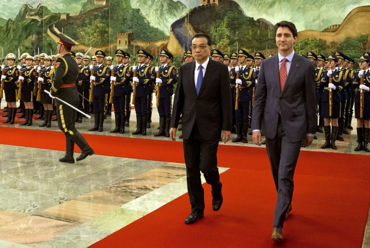 Prime Minister Justin Trudeau walks with Chinese Premier Li Keqiang during a welcome ceremony held at the Great Hall of the People in Beijing on Dec. 4, 2017. (AP Photo/Ng Han Guan)