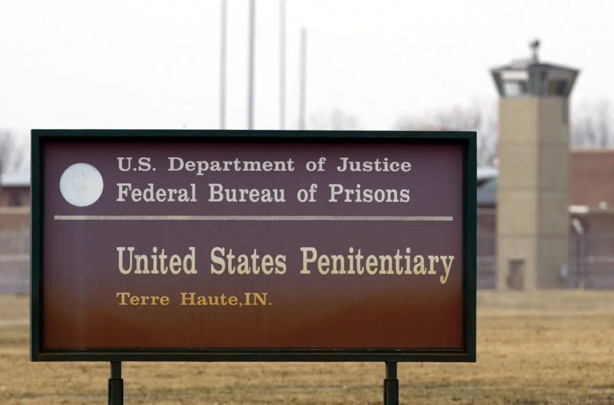 A guard tower flanks the sign at the entrance to the U.S. Penitentiary in Terre Haute, Ind., on March 17, 2003. (Michael Conroy/AP Photo)