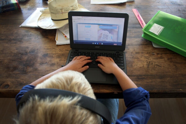 A child doing his schoolwork at his family home in a file photo taken on April 5, 2020. (Lisa Maree Williams/Getty Images)