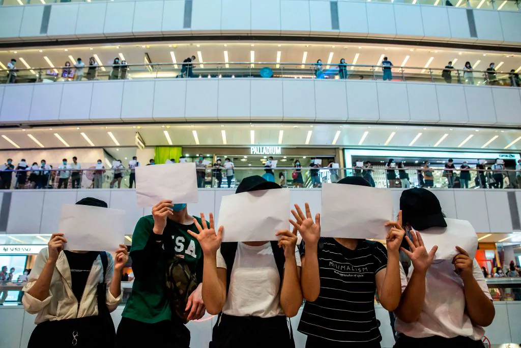 Protesters hold up blank papers during a demonstration in a mall in Hong Kong on July 6, 2020. (Isaac Lawrence/AFP via Getty Images)