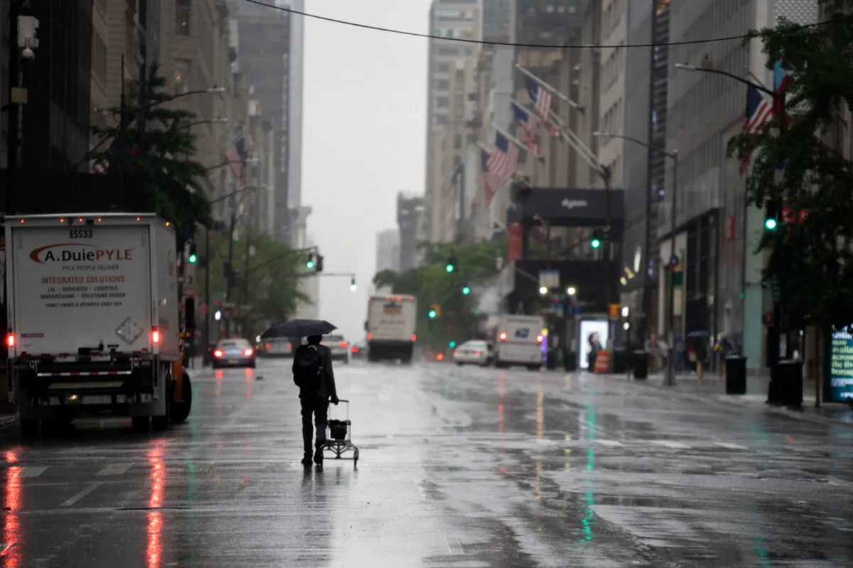 A person walks down 5th Avenue as tropical storm Fay rolls in on July 10, 2020, in New York. (David Dee Delgado/Getty Images)