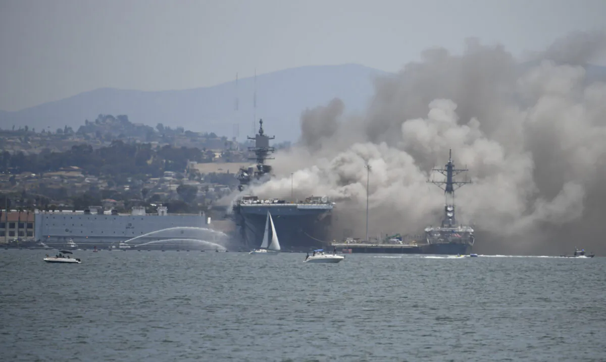 Smoke rises from the USS Bonhomme Richard at Naval Base San Diego, in San Diego after an explosion and fire Sunday on board the ship at Naval Base San Diego, on July 12, 2020. (Denis Poroy/AP Photo)