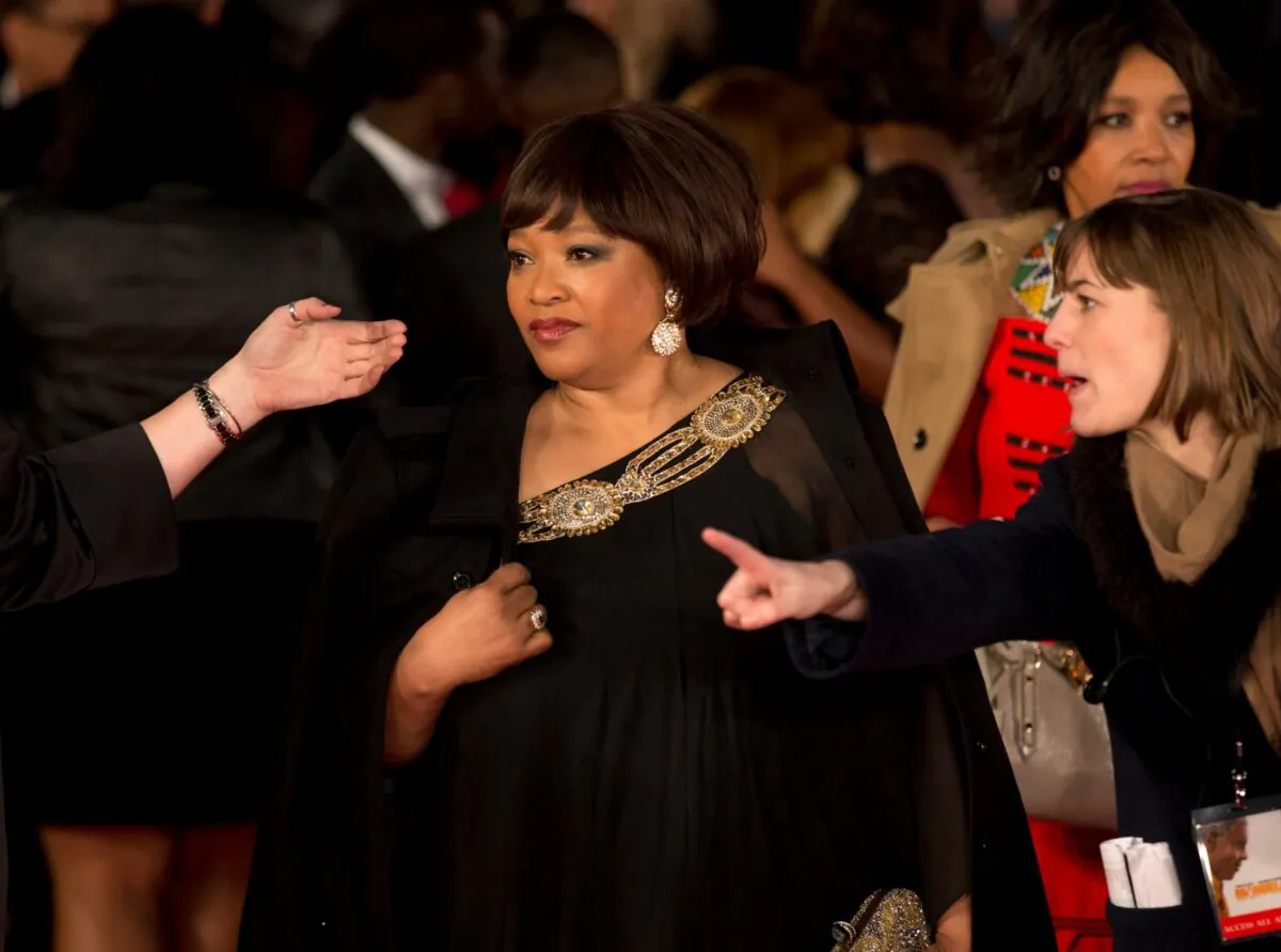 Zindzi Mandela, the daughter of the late Nelson Mandela poses for photographers as she arrives to attend the UK premiere of the movie "Mandela: Long Walk to Freedom" at a cinema in London, UK., on Dec. 5, 2013. (Matt Dunham/File/AP Photo)