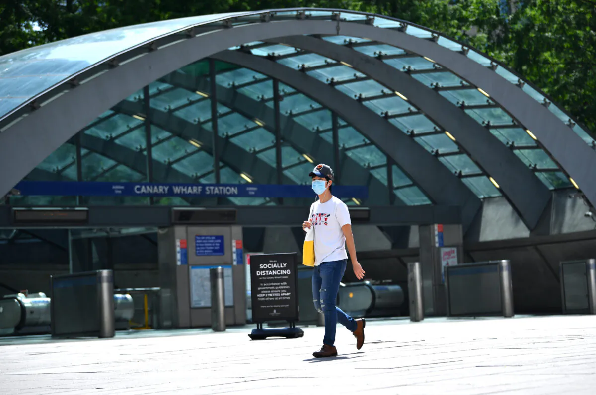 A person wearing a protective face mask is seen in Canary Wharf, following the outbreak of the coronavirus disease (COVID-19), London, Britain, on May 27, 2020. (Dylan Martinez/Reuters)
