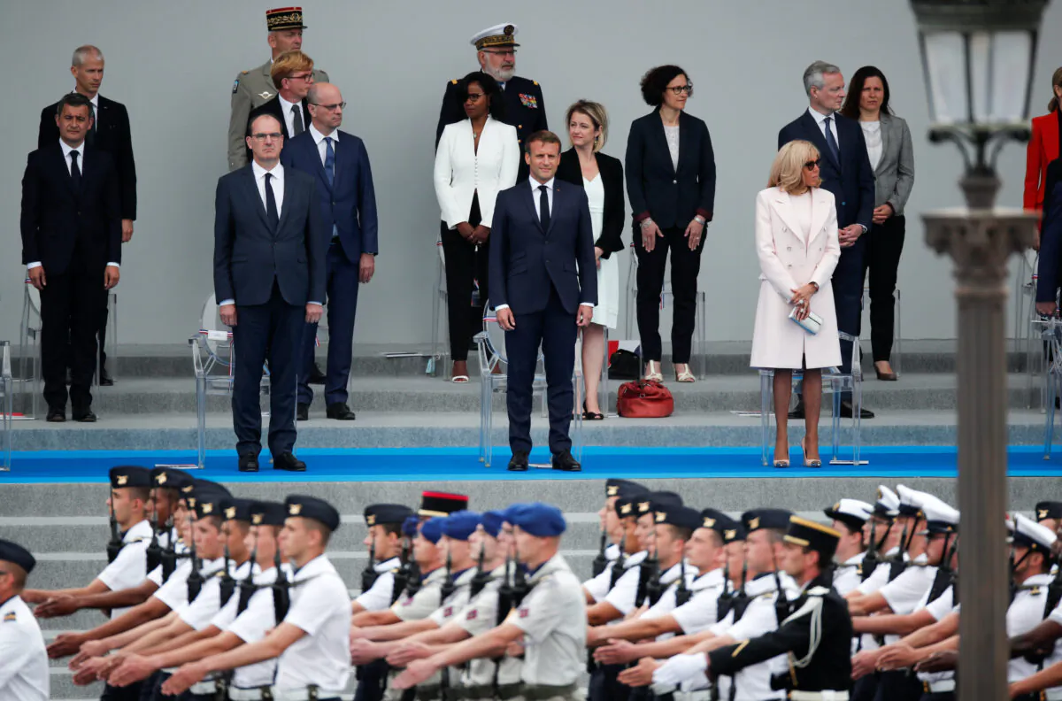 French President Emmanuel Macron, his wife Brigitte Macron and French Prime Minister Jean Castex attend the Bastille Day celebrations on Place de la Concorde in Paris, France, on July 14, 2020. (Benoit Tessier/Reuters)