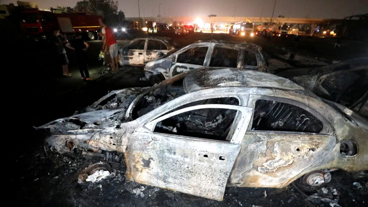 Burned vehicles are seen following a fire that broke out in Egypt's Shuqair-Mostorod crude oil pipeline, at the beginning of Cairo-Ismailia road, Egypt, on July 14, 2020. (Mohamed Abd El Ghany/Reuters)