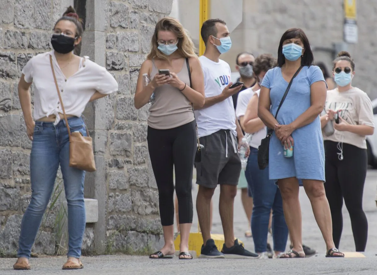 People wait to be tested for COVID-19 at a clinic in Montreal on July 12, 2020. (The Canadian Press/Graham Hughes)