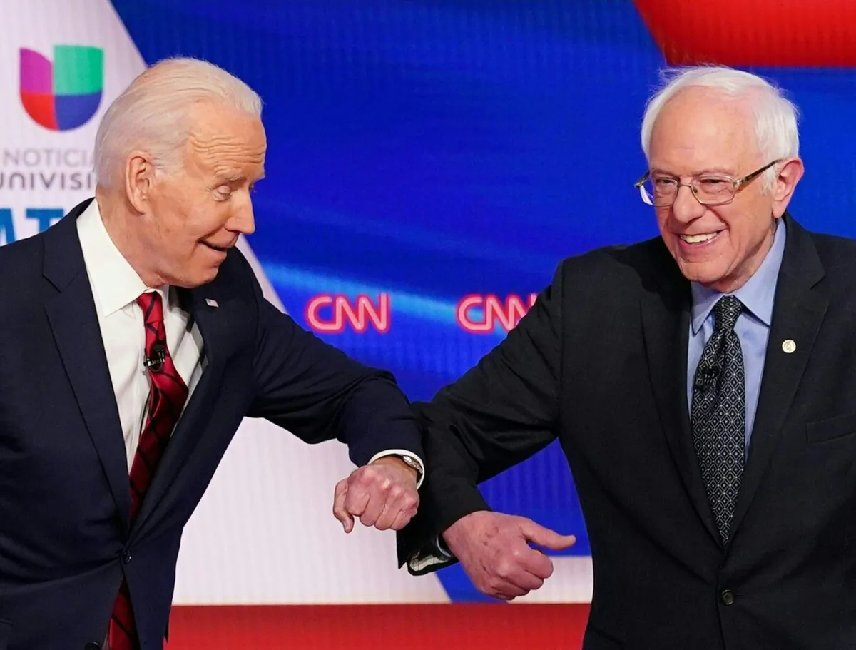 Democratic presidential hopefuls former Vice President Joe Biden (L) and Sen. Bernie Sanders greet each other with a safe elbow bump before the start of the 11th Democratic Party 2020 presidential debate in a CNN Washington Bureau studio in Washington on March 15, 2020. (Mandel Ngan/AFP via Getty Images)