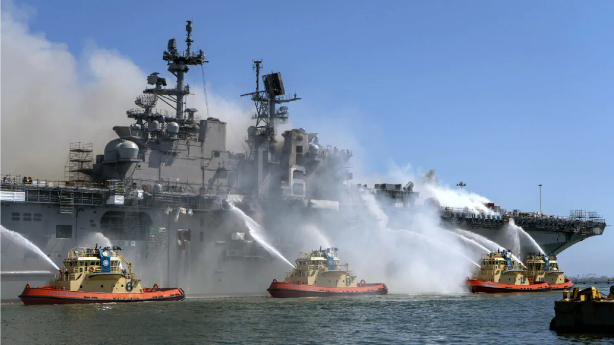 In this U.S. Navy released handout, Sailors and Federal Firefighters combat a fire onboard USS Bonhomme Richard (LHD 6) at Naval Base San Diego, July 12.