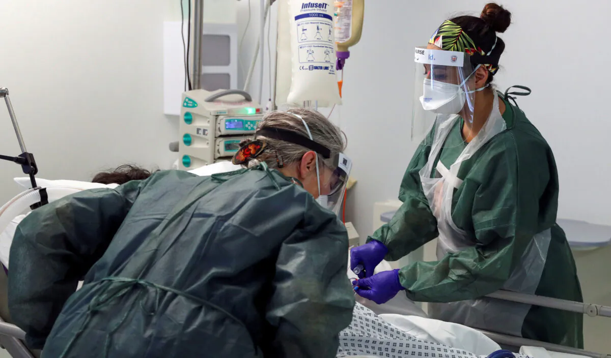 Nurses care for a patient in an Intensive Care ward treating victims of the coronavirus disease (COVID-19) in Frimley Park Hospital in Surrey, Britain, May 22, 2020. (Steve Parsons/Reuters)