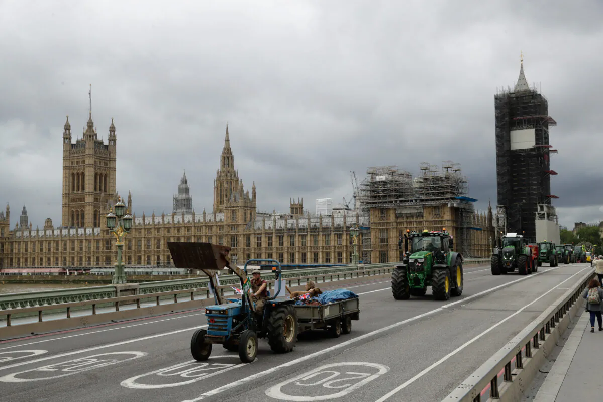 Farmers from the group Save British Farming drive tractors across Westminster Bridge in a protest against cheaply produced lower standard food being imported from the United States after Brexit that will undercut them on July 8, 2020. (Matt Dunham/AP)