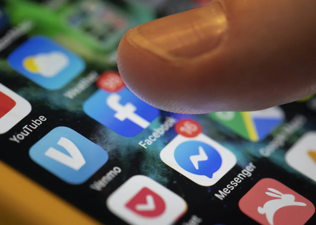 An iPhone displays the apps for Facebook and Messenger in New Orleans on Aug. 11, 2019. (Jenny Kane/AP Photo)