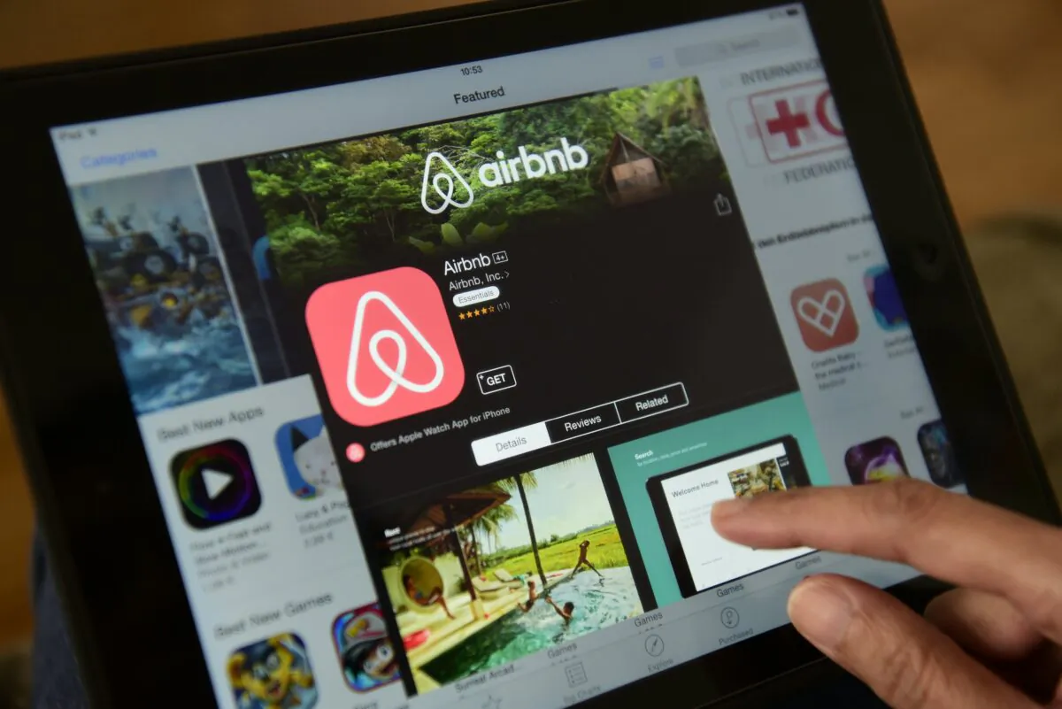 A woman browses the Airbnb website on a tablet in Berlin on April 28, 2016. (John MacDougall/AFP via Getty Images)