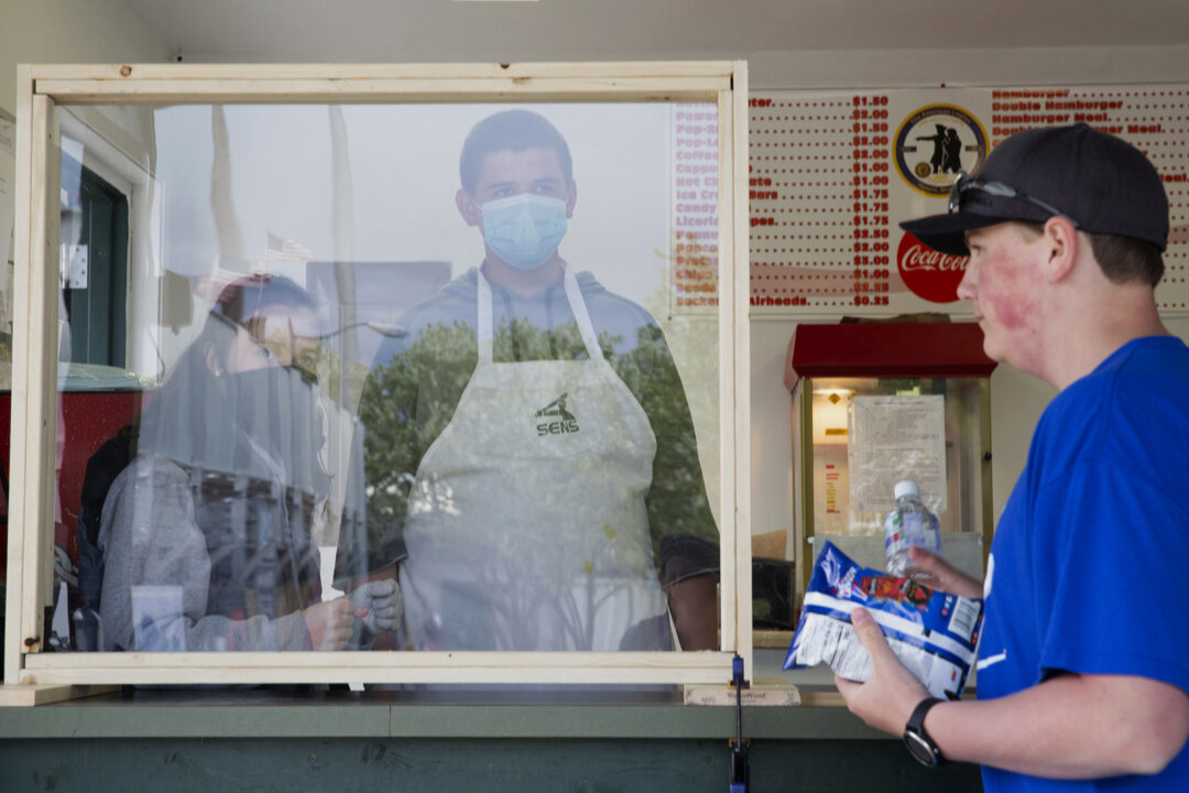 Concession stand employees wait on a customer in Helena, Mont., on May 21, 2020. (Janie Osborne/Getty Images)