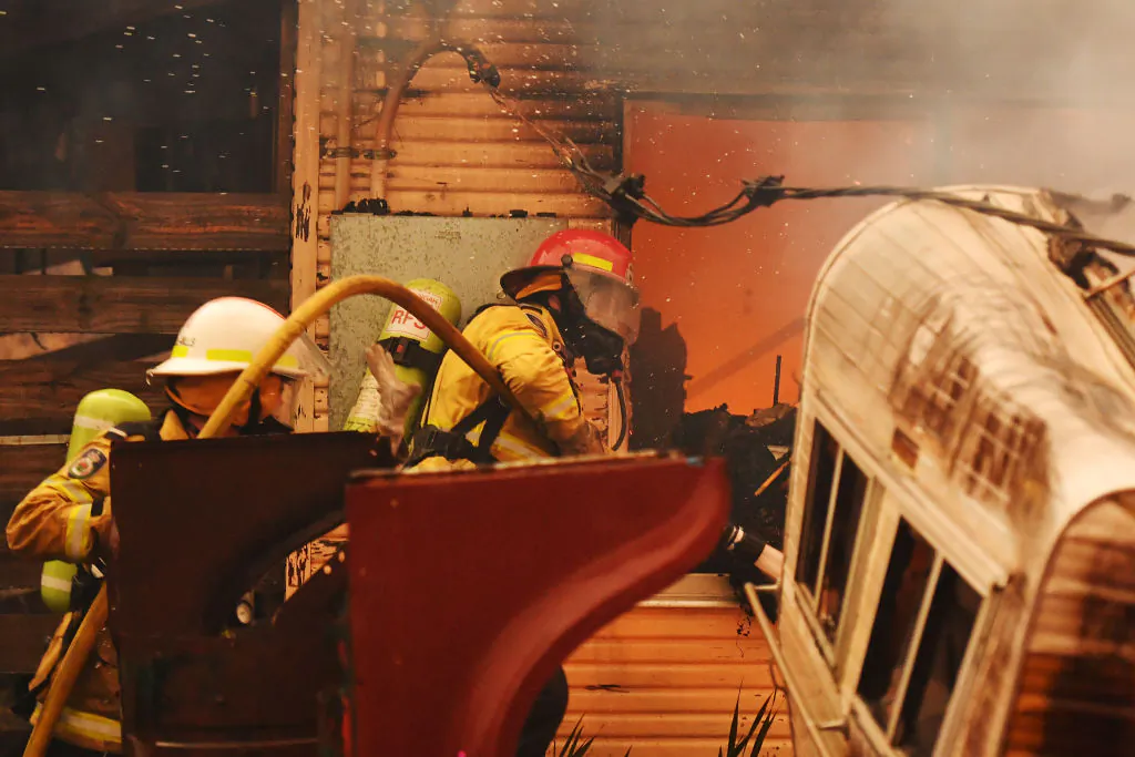 Rural Fire Service firefighters extinguish a fire on a property on January 23, 2020 in Moruya, Australia. (Sam Mooy/Getty Images)