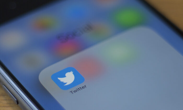  Twitter logo is seen on a phone in this photo illustration in Washington on July 10, 2019. (Alastair Pike/AFP via Getty Images)
