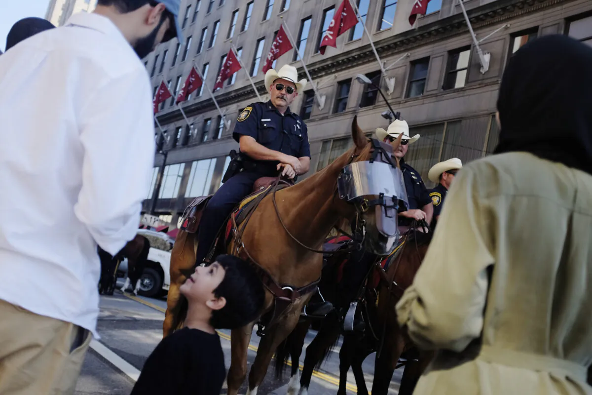 A young boy and his family members look at the horses of the Fort Worth, Texas, mounted police on the third day of the Republican National Convention in Cleveland, Ohio, on July 20, 2016. (Dominick Reuter/AFP via Getty Images)