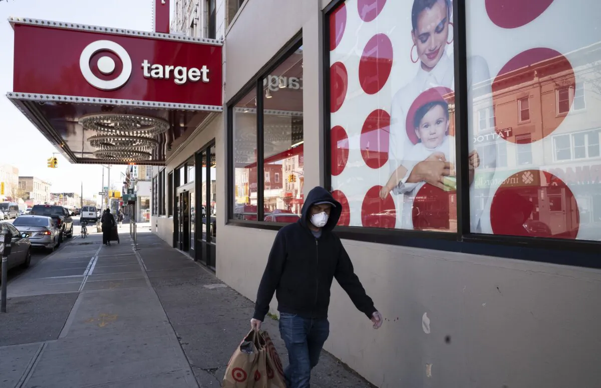 In this April 6, 2020 file photo, a customer wearing a mask carries his purchases as he leaves a Target store during the coronavirus pandemic in the Brooklyn borough of New York. (Mark Lennihan/AP Photo)