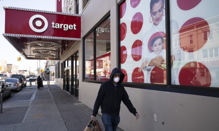 In this April 6, 2020 file photo, a customer wearing a mask carries his purchases as he leaves a Target store during the coronavirus pandemic in the Brooklyn borough of New York. (Mark Lennihan/AP Photo)