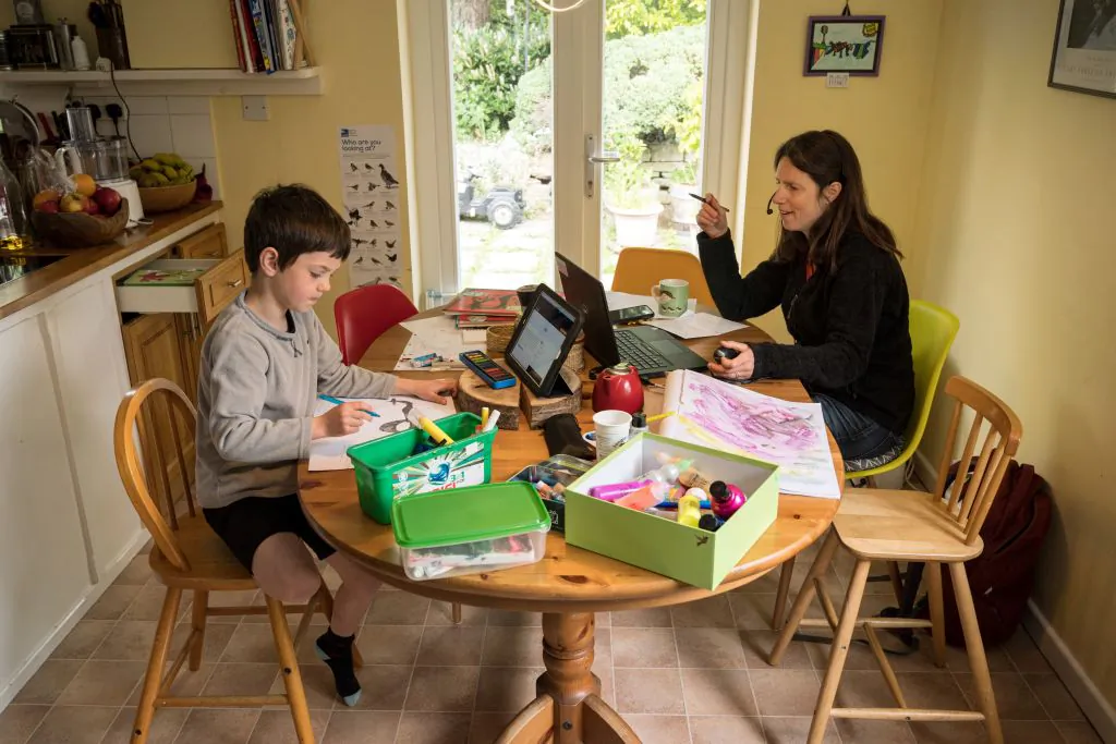 Six-year-old Leo and his mother Moira, an employee of a regional council, working from home in the village of Marsden, near Huddersfield, northern England on May 15, 2020. (Oli Scarff/AFP via Getty Images)